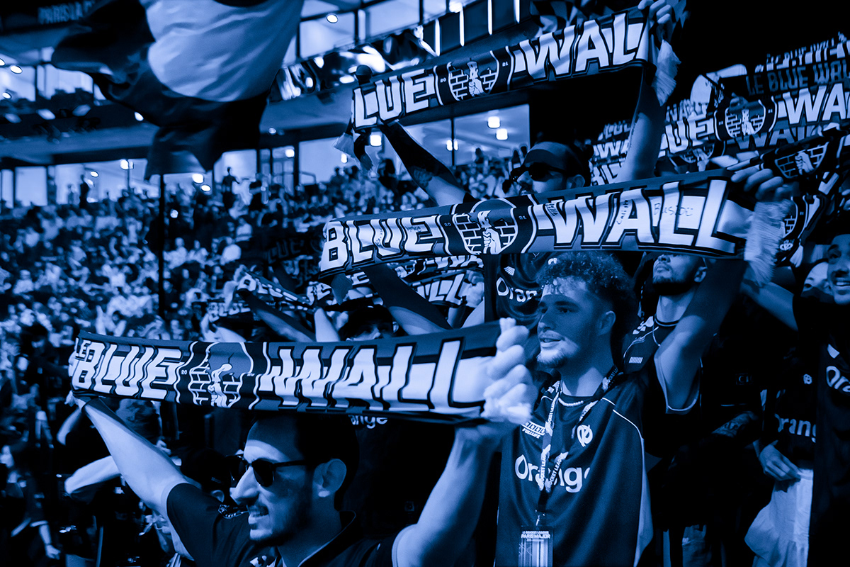 Le Blue Wall supporters holding custom esports scarves during a Karmine Corp event